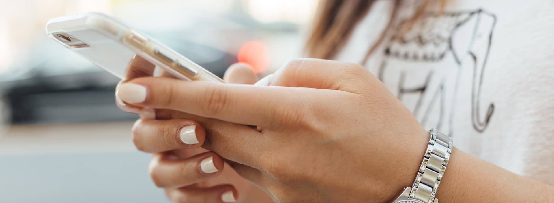 Girl holding an iPhone texting